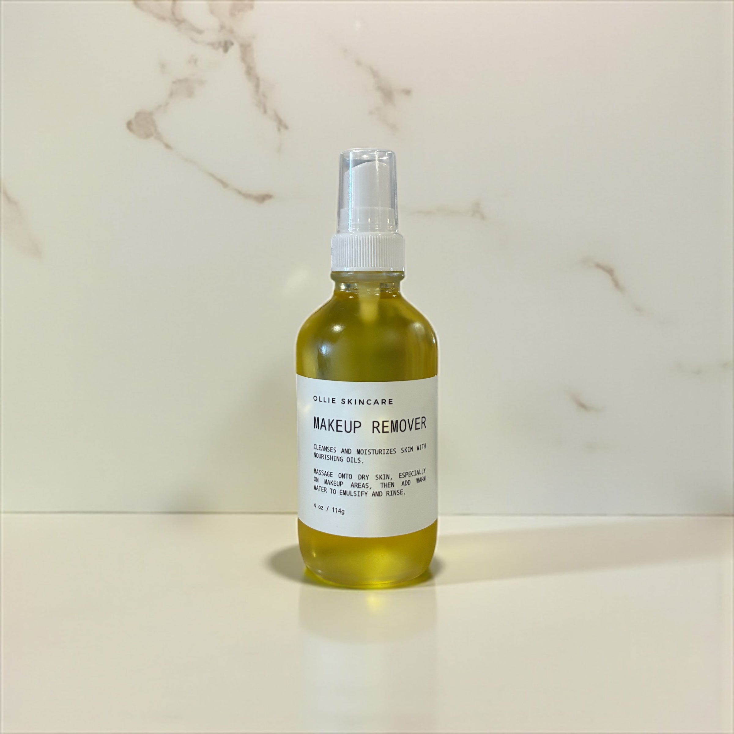 Bottle of makeup remover on a marble surface