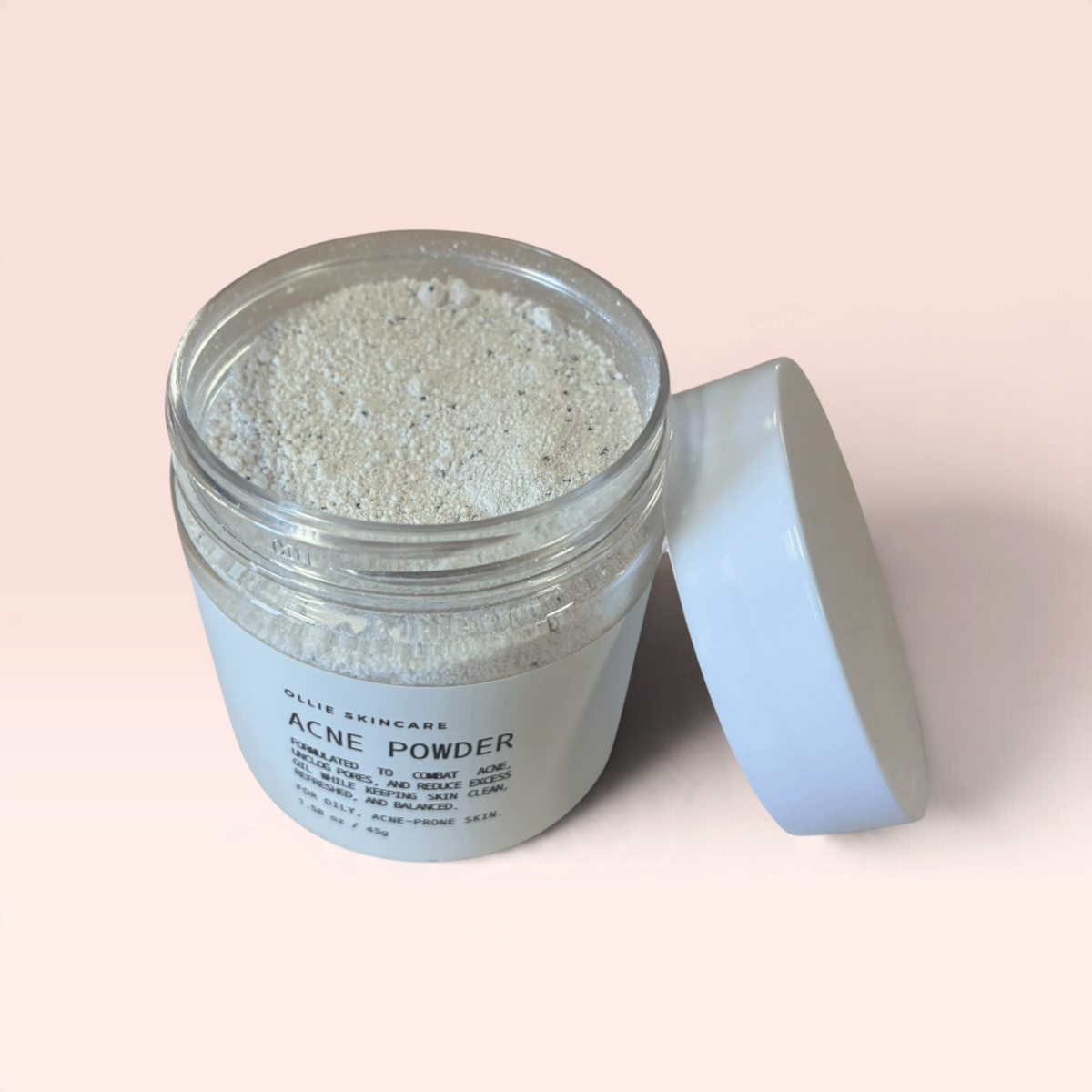 Cleansing grains in a transparent jar with a white lid, ideal for acne treatment.