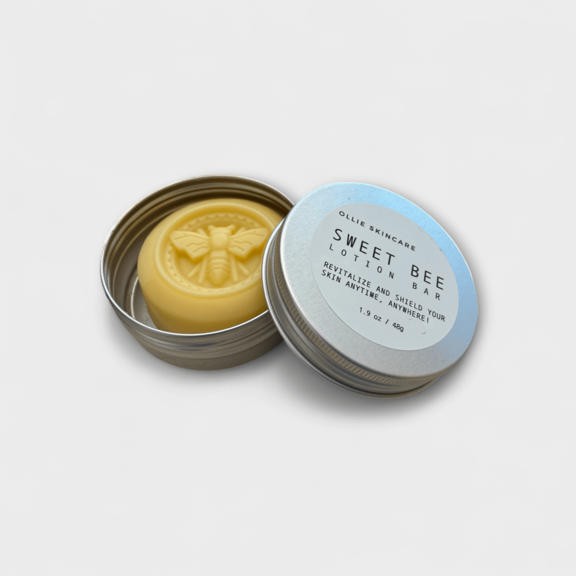 Solid Lotion Bar in tin, featuring all-natural formula for dry skin with beeswax and cocoa butter.