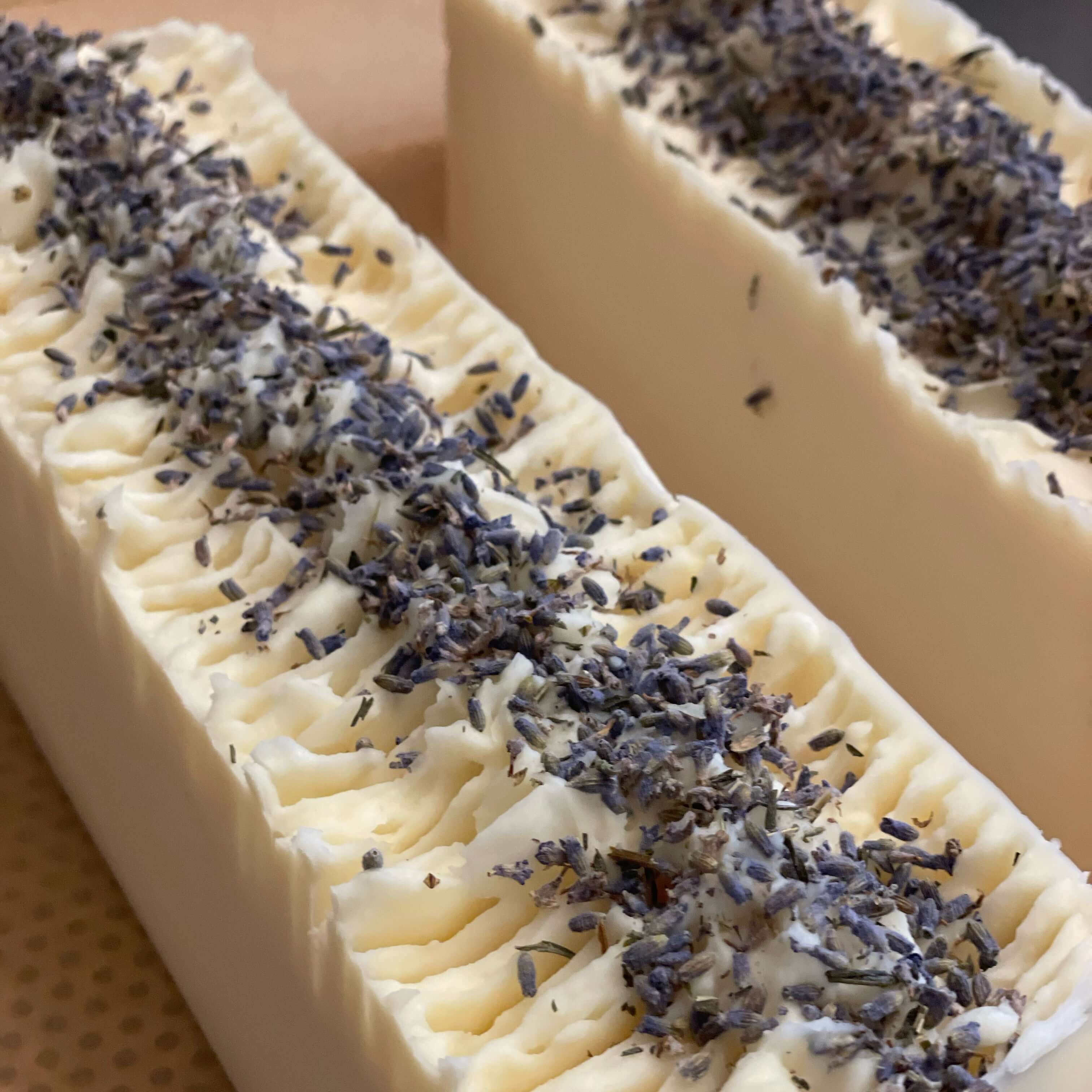 Lavender Goat Milk Soap with a creamy texture and lavender sprigs on top, perfect for gentle cleansing.