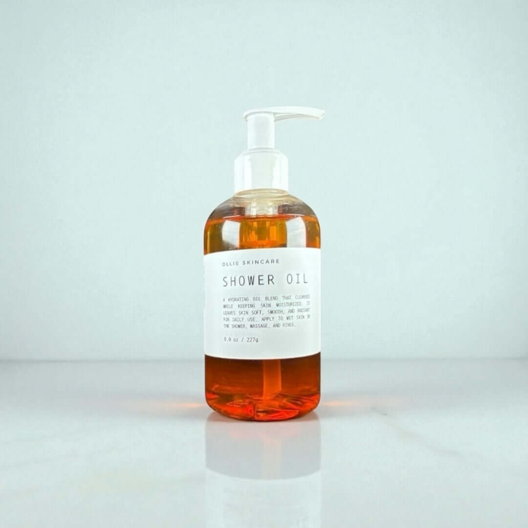Ollie Skincare Shower Oil in a clear pump bottle, showcasing luxurious moisturizing benefits for soft, glowing skin.