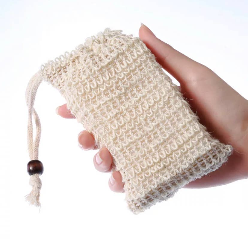 Sisal Soap Saver Bag held in hand, showcasing its natural fiber and drawstring design.