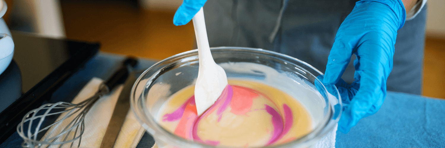 Ultimate Guide to Cold Process Soap Making: Step-by-Step - Mixing colorful soap ingredients in a glass bowl.