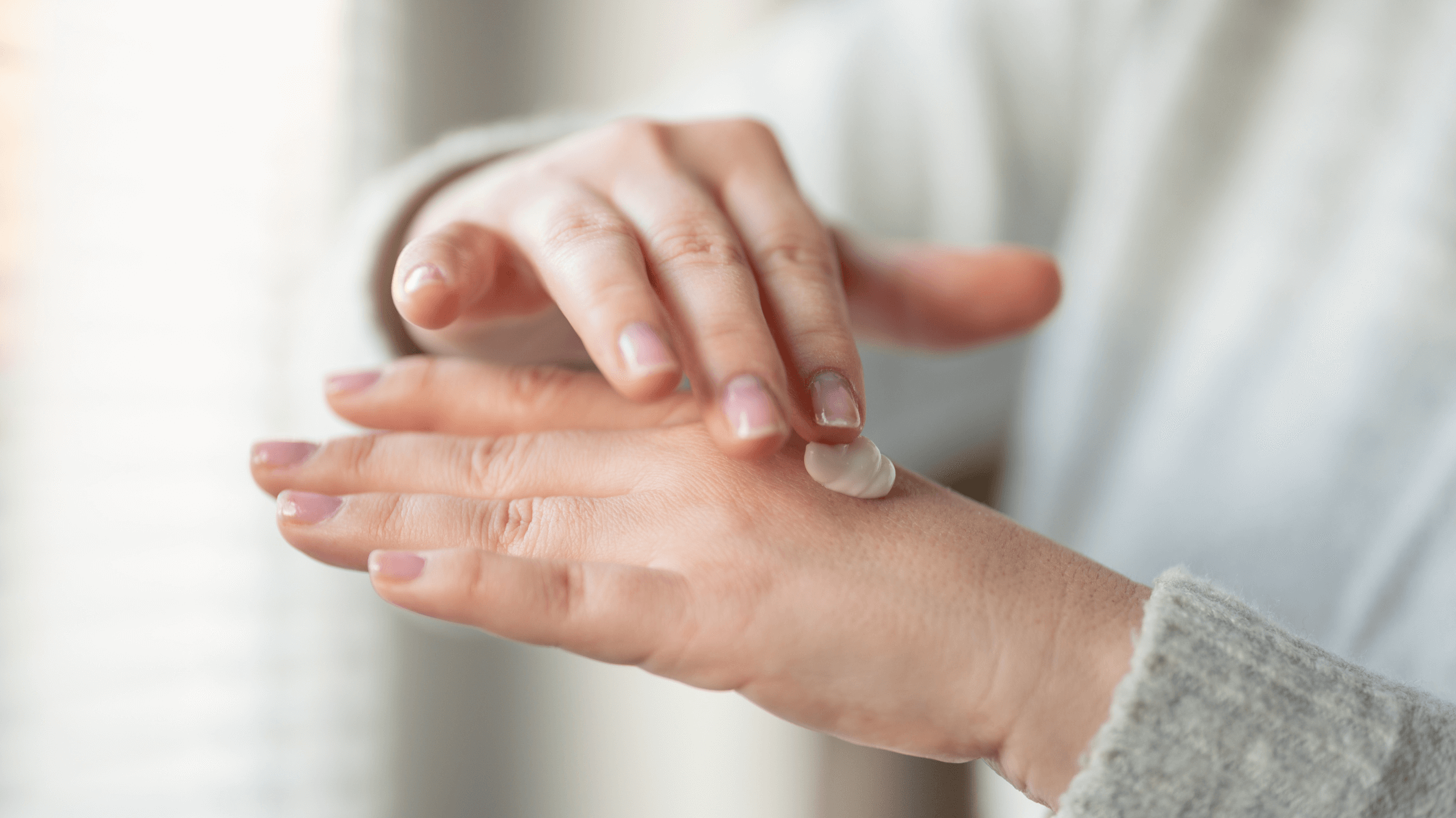 Treating Dry Skin: Proven Methods for Restoring Moisture - person applying moisturizer to dry hands.