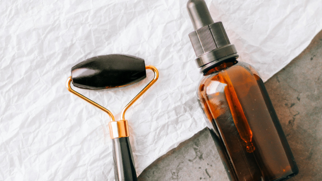 Clean Face Oil: The Ultimate Guide to Natural Skin Nourishment with a jade roller and dropper bottle.