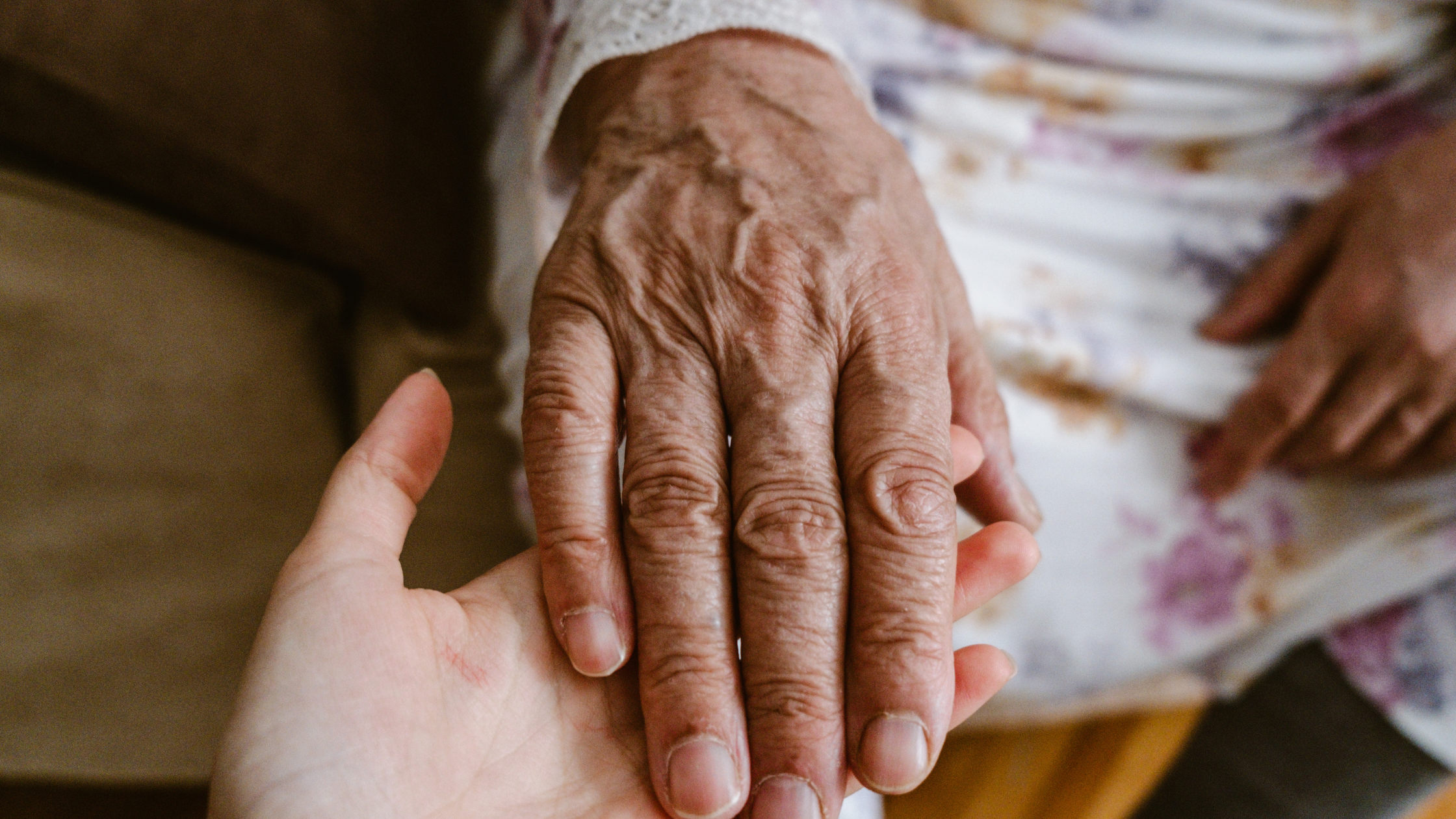 Two hands holding each other