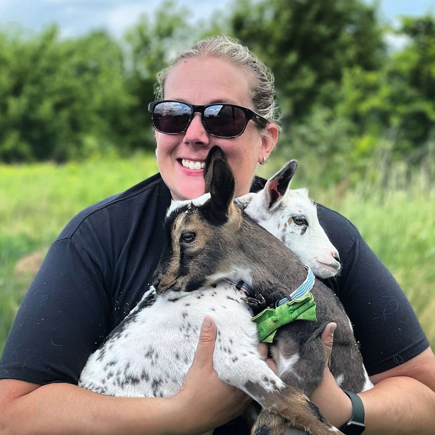 DIY Goat Milk Soap: Easy Homemade Recipe for Natural Skincare with a woman holding two adorable baby goats.