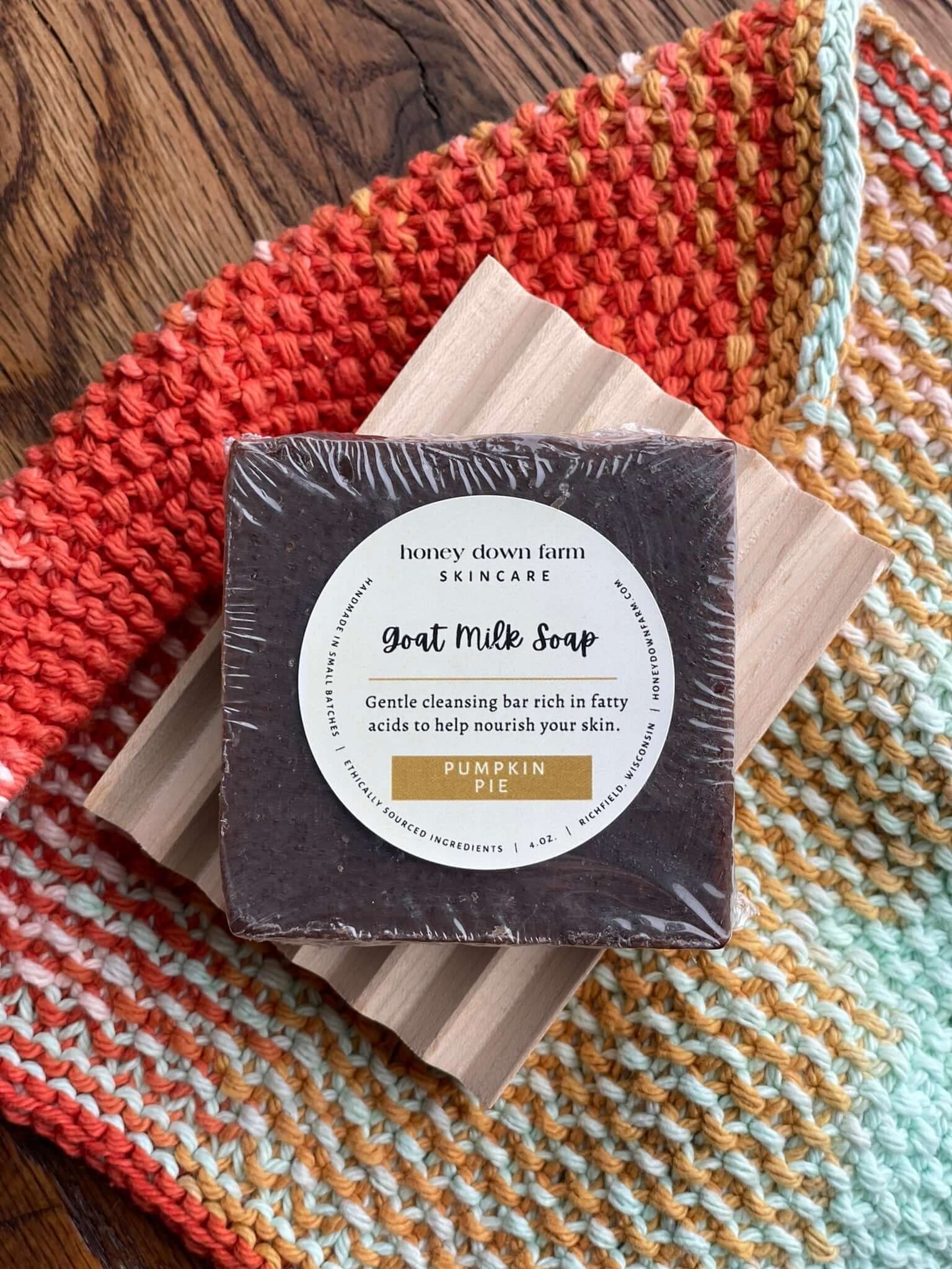 The Down & Dirty on Goat Milk Soap - Goat milk soap bar with pumpkin pie scent on a wooden display.