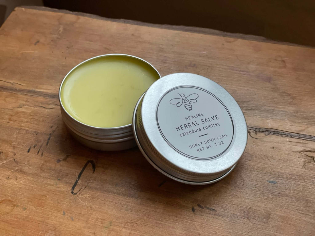 Healing herbal salve in a tin on a wooden surface, ideal for skincare routines and moisturizing, pick the best moisturizer.