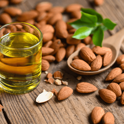 Sweet Almond Oil Benefits: A Natural Boost for Your Skincare Routine with almonds and oil on a wooden surface.