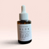 OLLIE SKINCARE Skin Glow facial serum in a 1 oz amber glass dropper bottle against a soft pink background.