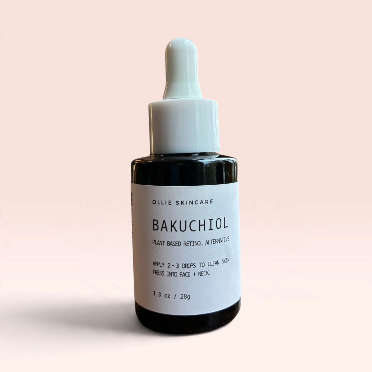 OLLIE SKINCARE Bakuchiol Facial Oil in a 1 oz amber glass dropper bottle with a white cap against a soft pink background