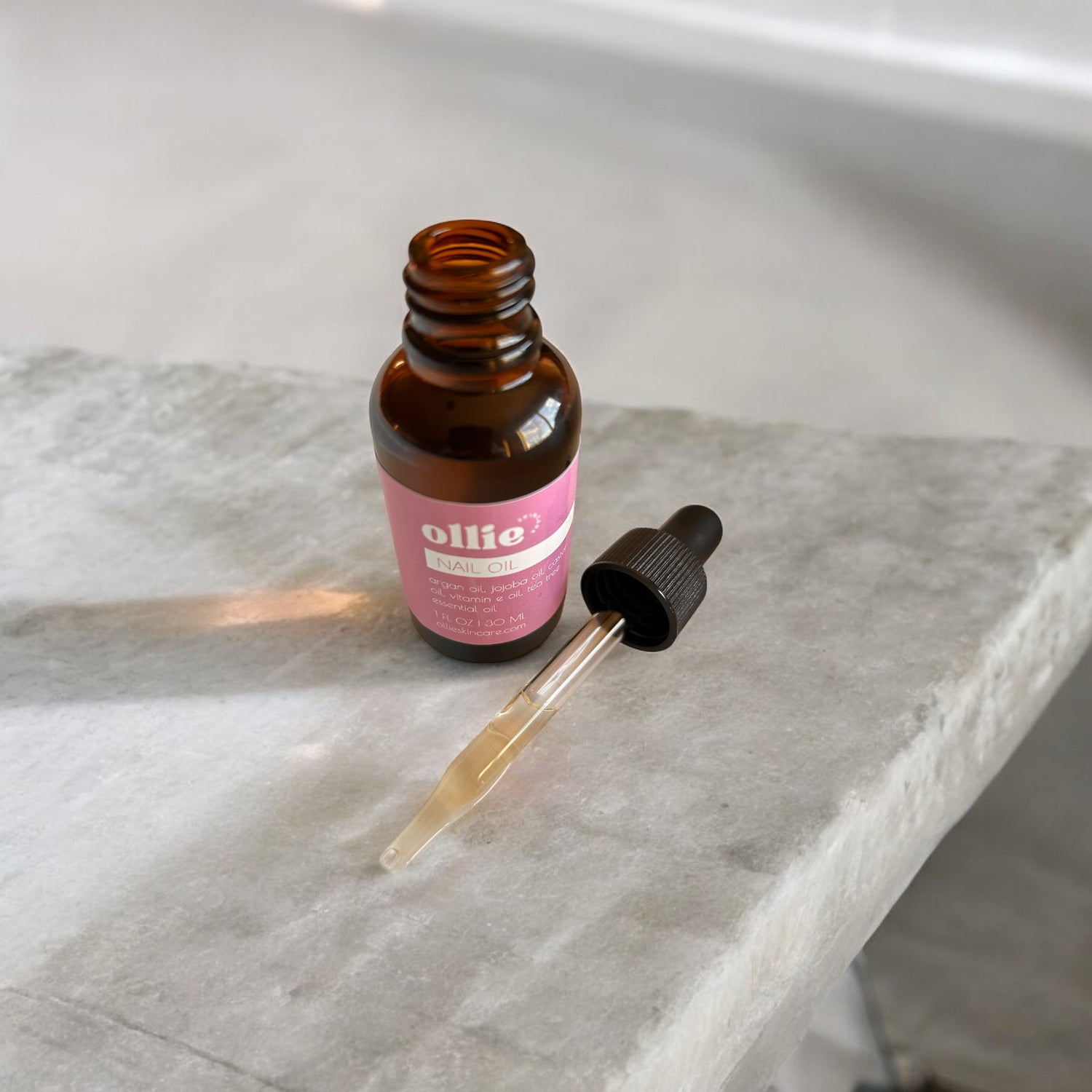 Ollie Skincare Nail Oil open on counter