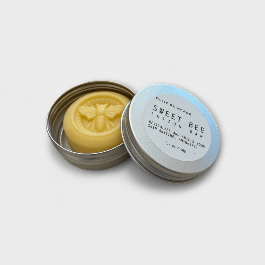 Solid Lotion Bar in tin, featuring all-natural formula for dry skin with beeswax and cocoa butter.