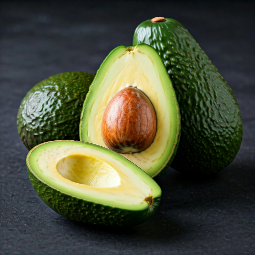 Avocado with a cut half showing the seed on a dark background