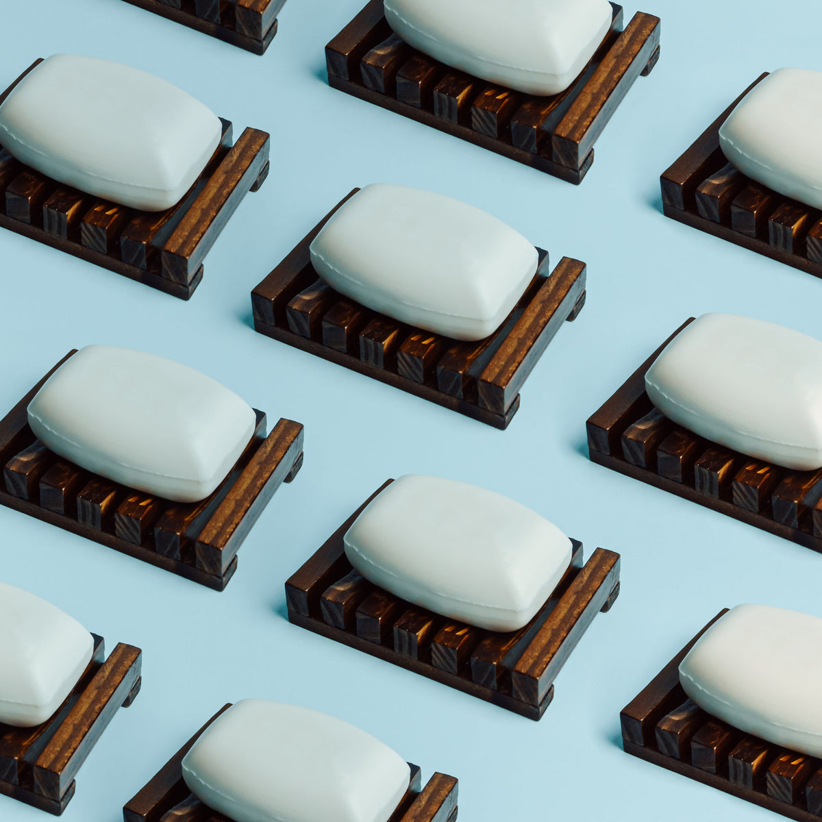 Handmade goat milk soap bars on a wooden surface