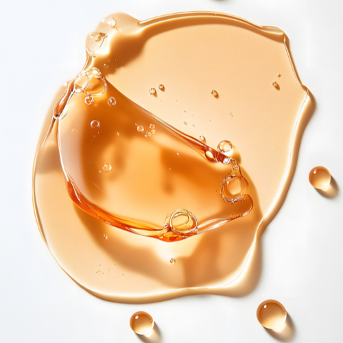 Amber-colored liquid with bubbles on a white background