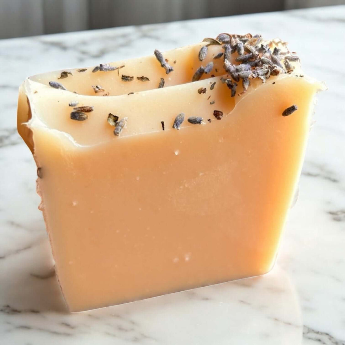 Lavender Goat Milk Soap bar with lavender pieces on top, handcrafted for sensitive skin.