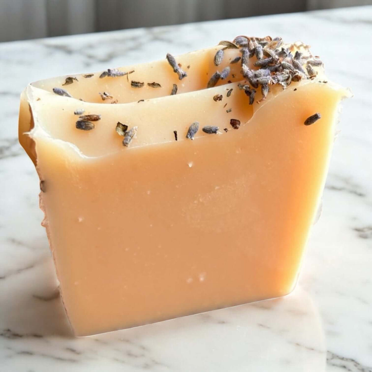 Lavender Goat Milk Soap bar with lavender pieces on top, handcrafted for sensitive skin.