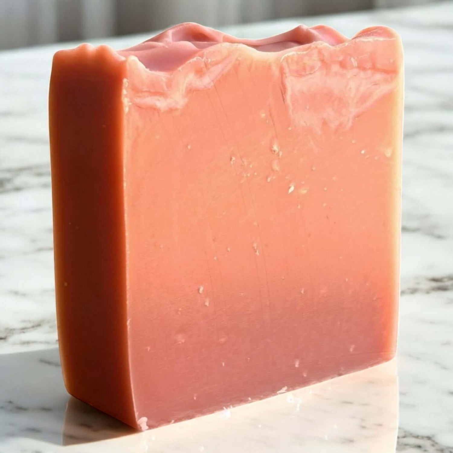 Handmade clay soap bar in soft pink hue, showcasing artisanal quality and nourishing ingredients for facial cleansing.
