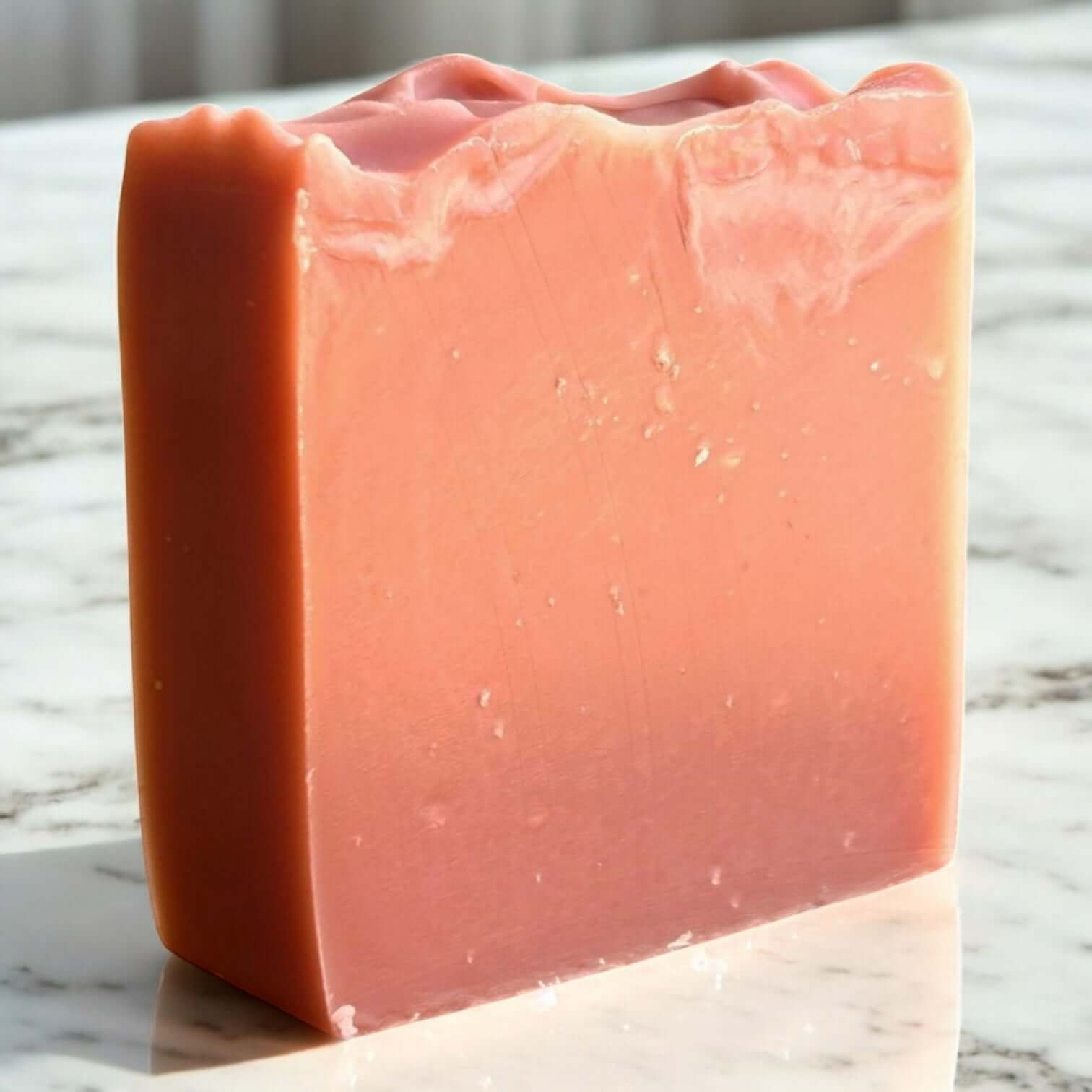 Handmade clay soap bar in soft pink hue, showcasing artisanal quality and nourishing ingredients for facial cleansing.