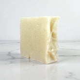 Handmade clay soap bar made with goat milk and rose kaolin clay, perfect for gentle cleansing and skin purification.