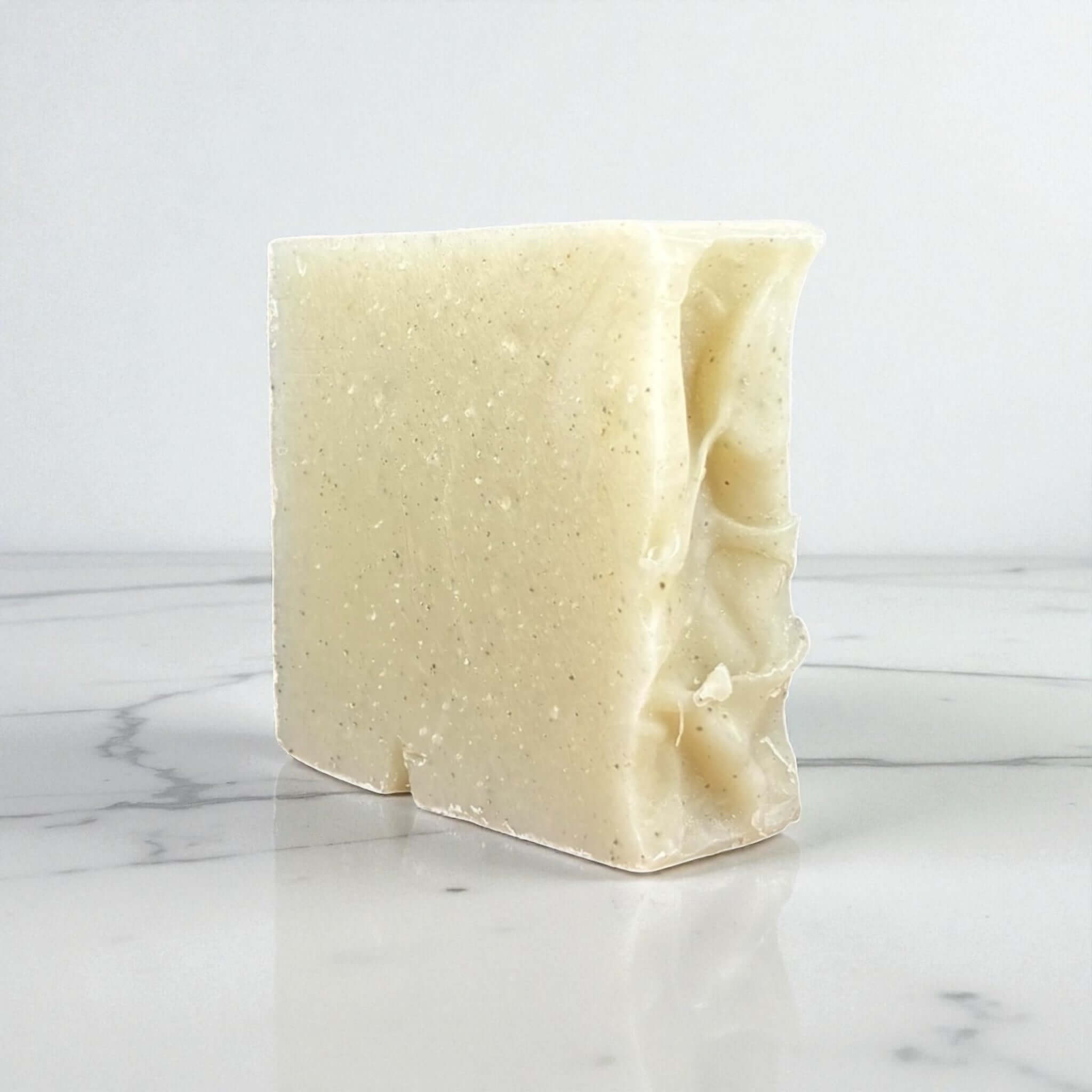 Handmade clay soap bar made with goat milk and rose kaolin clay, perfect for gentle cleansing and skin purification.