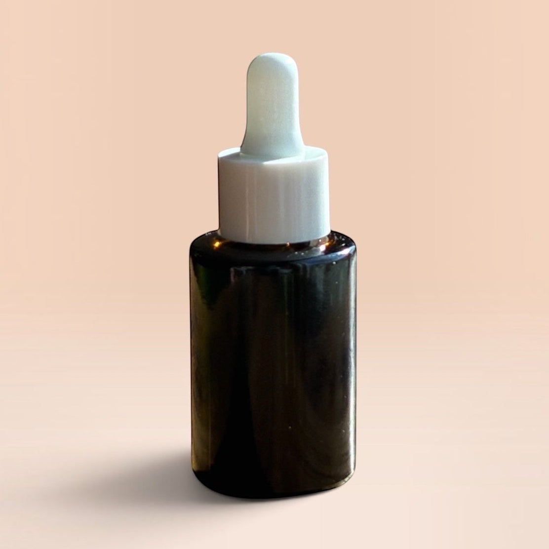 OLLIE SKINCARE Bakuchiol Facial Oil in a dark glass dropper bottle against a soft peach background.