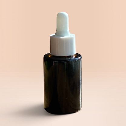 OLLIE SKINCARE Bakuchiol Facial Oil in a dark glass dropper bottle against a soft peach background.