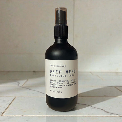 Ollie Skincare Deep Mend Magnesium Oil spray bottle on a marble surface