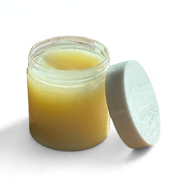 OLLIE SKINCARE nourishing makeup removing balm in a clear jar with a white lid, featuring a rich buttery texture.