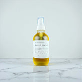 Ollie Skincare Makeup Remover in a glass bottle, effectively dissolves makeup and nourishes skin.