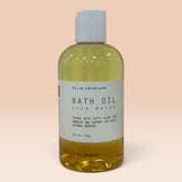Ollie Skincare bath oil in a clear bottle with a white cap, formulated for deep skin hydration.