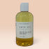 Ollie Skincare bath oil in a clear bottle with a white cap, formulated for deep skin hydration.