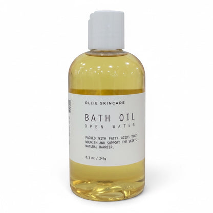 OLLIE SKINCARE Open Water bath oil in a clear 8.5 oz bottle with a white cap for deep skin hydration.