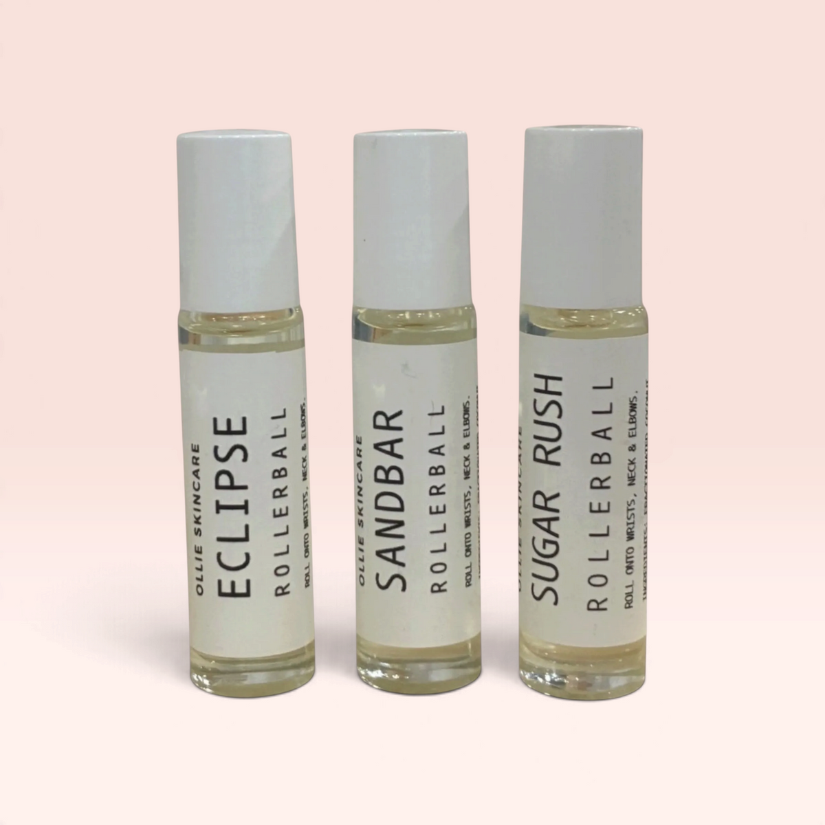 OLLIE SKINCARE rollerball fragrance trio featuring Eclipse, Sandbar, and Sugar Rush scents in clear glass vials.
