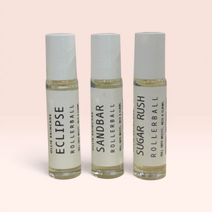 OLLIE SKINCARE rollerball fragrance trio featuring Eclipse, Sandbar, and Sugar Rush scents in clear glass vials.