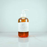 Ollie Skincare Shower Oil in a clear pump bottle, showcasing luxurious moisturizing benefits for soft, glowing skin.