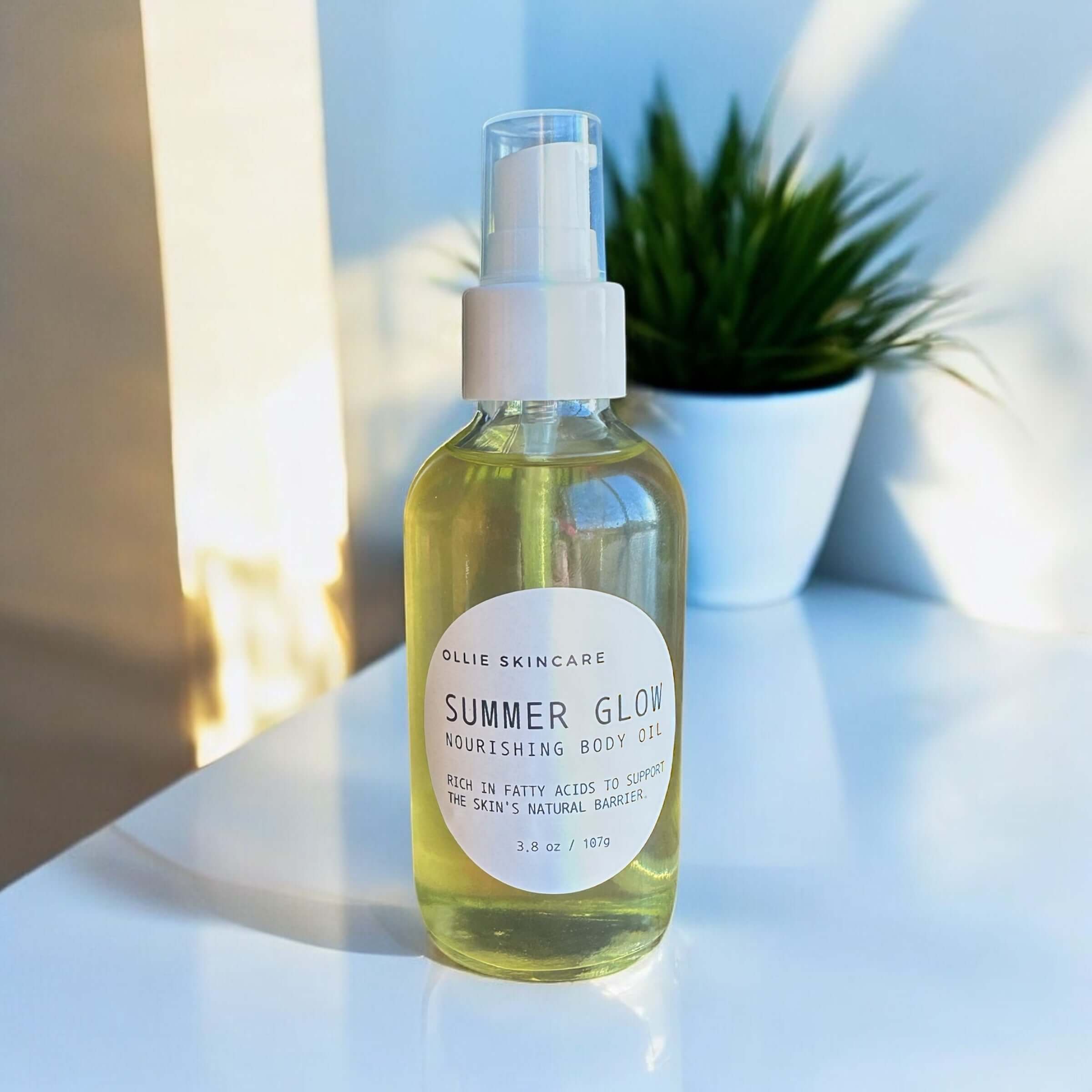 Summer Glow nourishing Body Oil in a glass bottle, essential fatty acids for skin hydration and radiance.