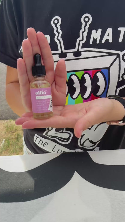 Cuticle Oil in a dropper bottle held in a hand, promoting nail care and nourishment.