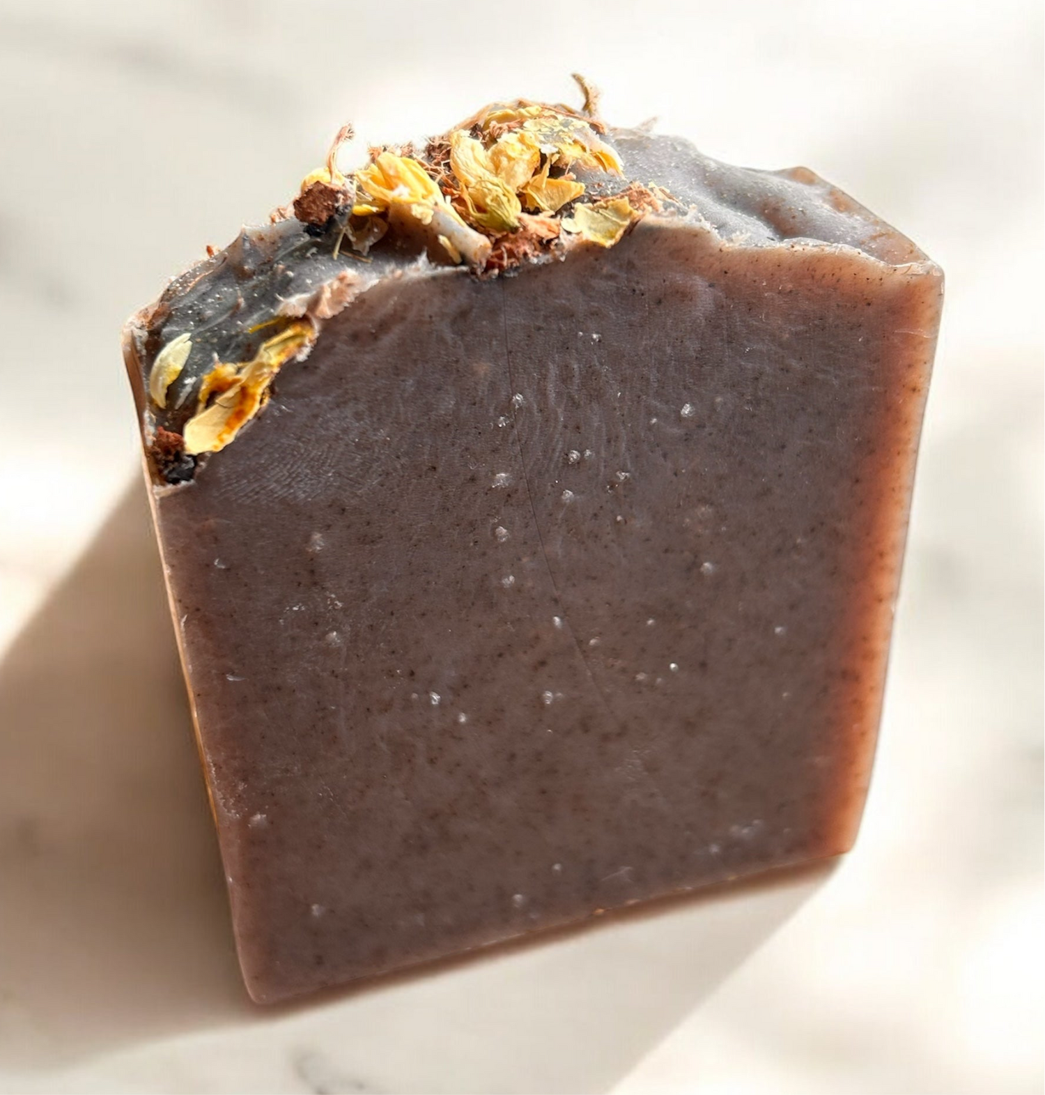 Roughcut Goat Milk Soap featuring natural ingredients and flower petals, handcrafted for gentle skin cleansing.