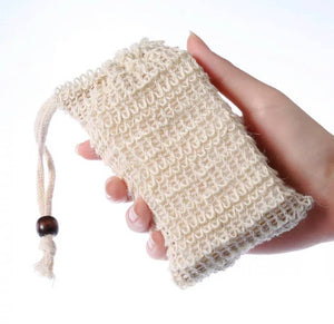 Sisal Soap Saver Bag held in hand, showcasing its natural fiber and drawstring design.
