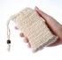 Sisal Soap Saver Bag held in hand, showcasing its natural fiber and drawstring design.