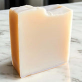 Unscented Goat Milk Soap bar on a marble surface showcasing its creamy texture.