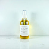 Body Oil in a glass bottle with spray top, featuring nourishing formula for skin hydration and radiance.